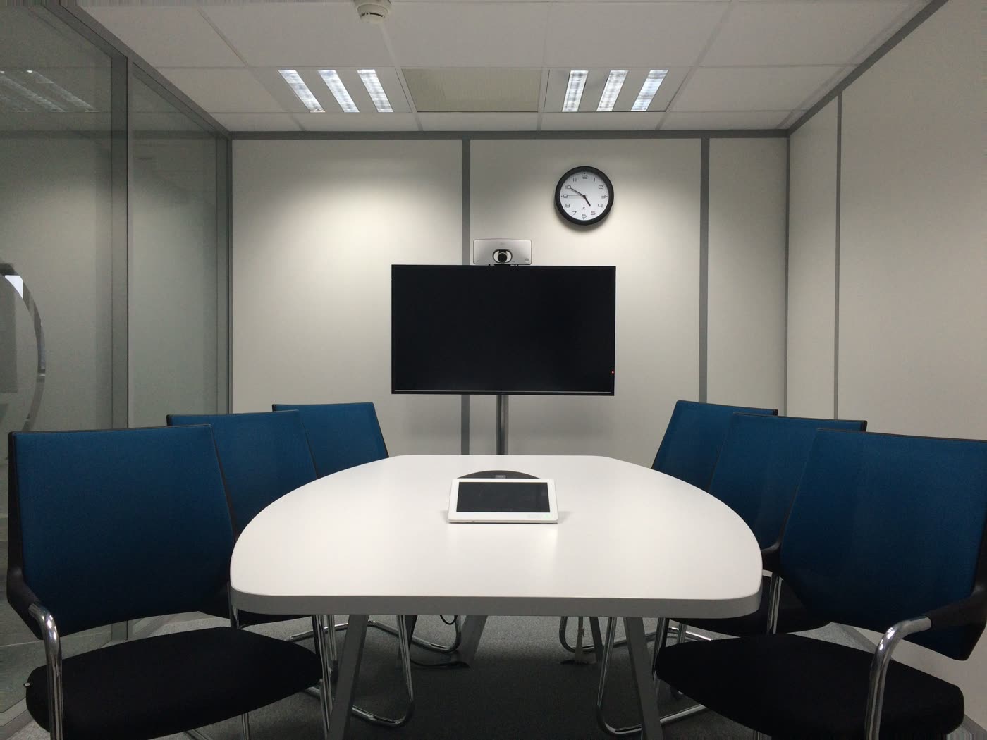 Wall-mounted camera and display integrated into a small meeting room